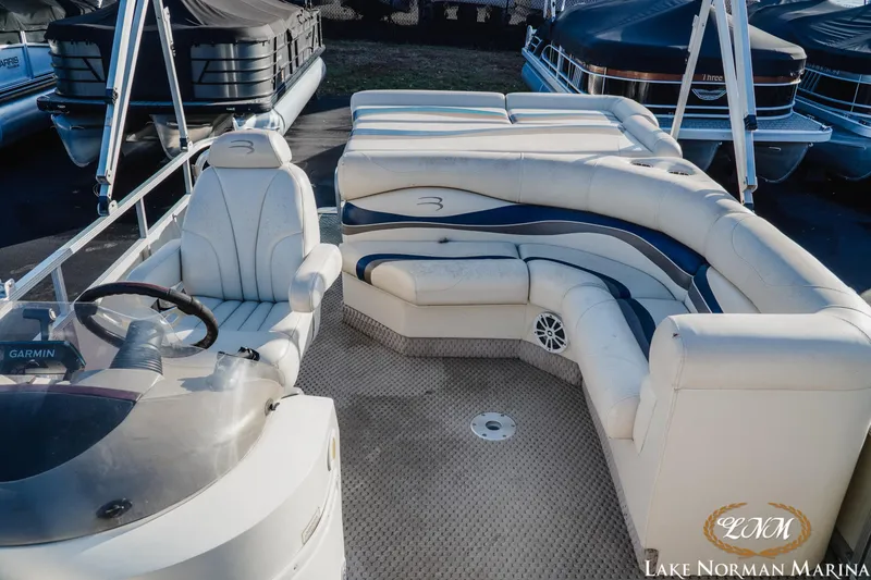 Slide: The Image of 2006 Bennington 2275 RL pontoon boat interior with white seating and steering console. - 6