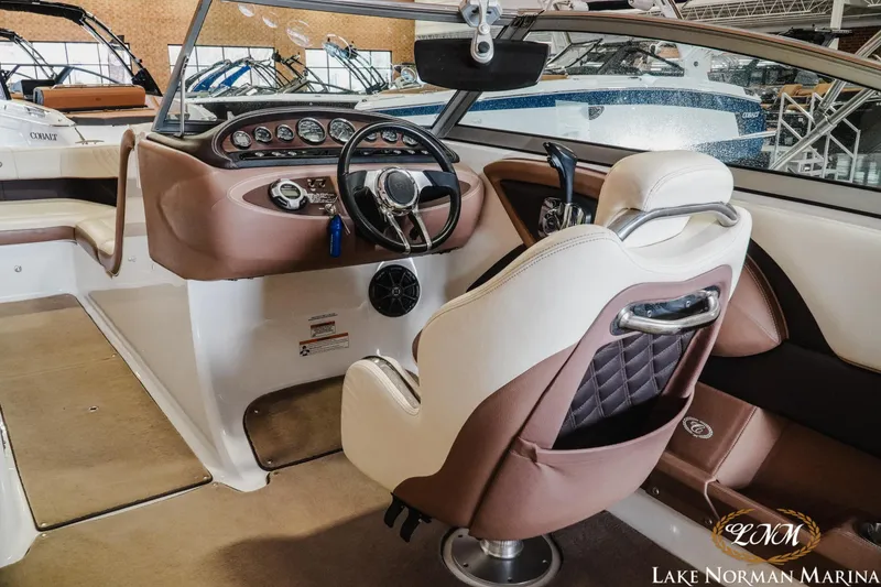 Slide: The Image of Interior of a 2013 Cobalt 232 boat with luxurious seating and modern dashboard. - 10