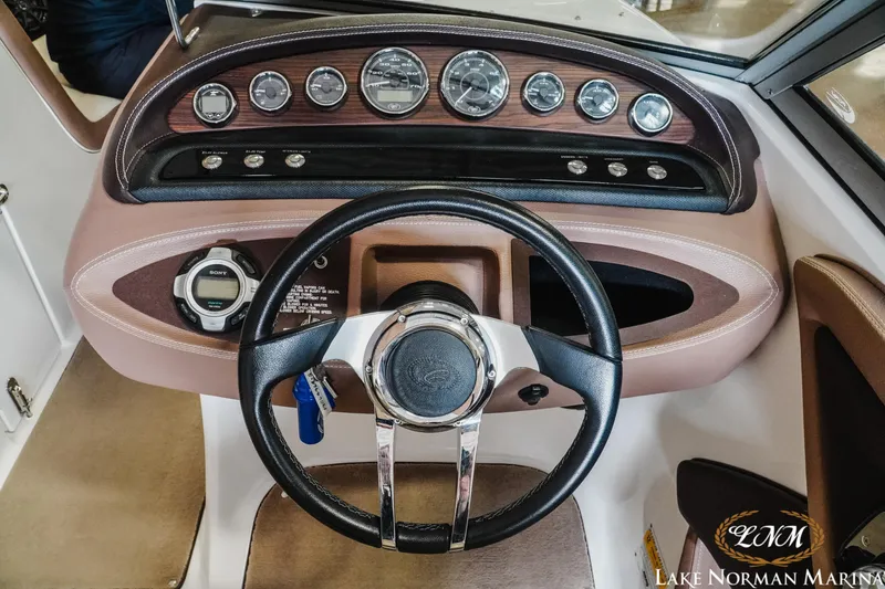Slide: The Image of Steering wheel and dashboard of a 2013 Cobalt 232 boat at Lake Norman Marina. - 11