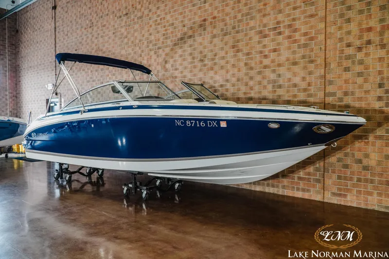 Slide: The Image of 2013 Cobalt 232 boat in showroom, blue and white, displayed at Lake Norman Marina. - 3