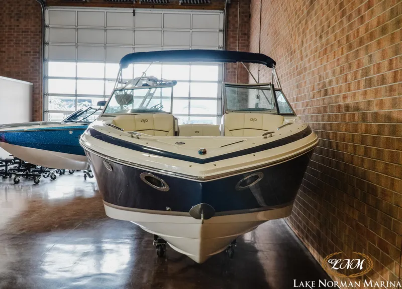 Slide: The Image of 2013 Cobalt 232 boat displayed indoors at Lake Norman Marina. - 4