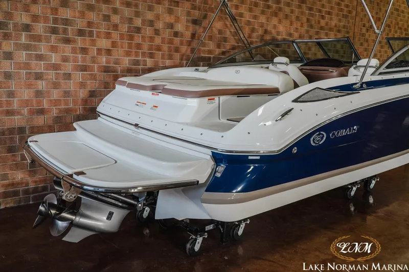 Slide: The Image of 2013 Cobalt 232 boat with blue and white exterior at Lake Norman Marina. - 7