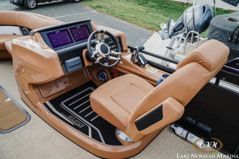 Slide: The Image of 2023 Harris FloteBote 230 Solstice boat interior with modern dashboard and steering wheel. - 9
