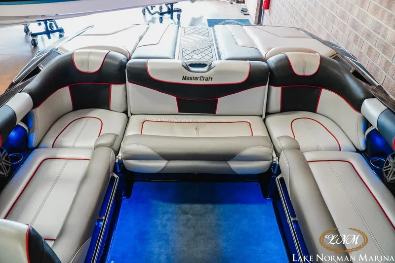 Slide: The Image of 2014 MasterCraft X-Star boat interior with gray and red seating at Lake Norman Marina. - 16