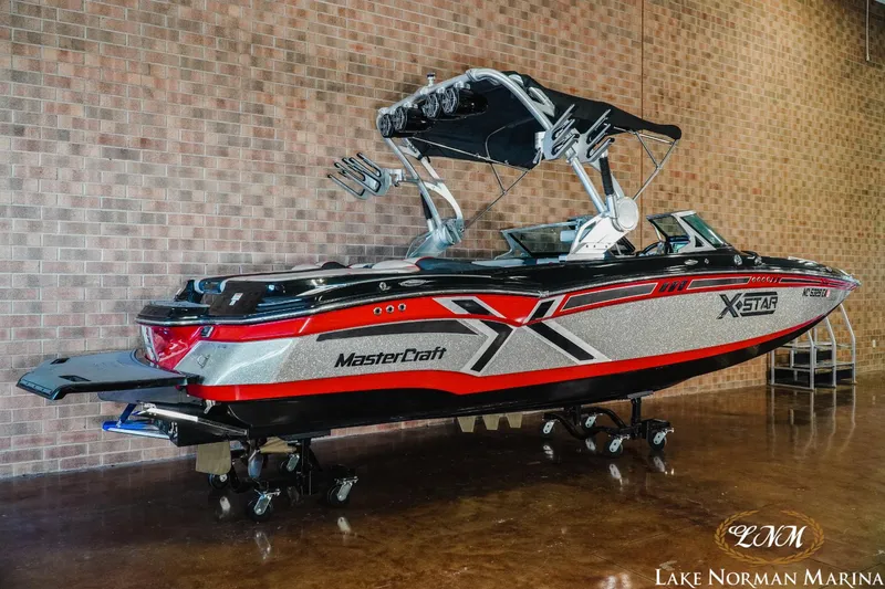 Slide: The Image of 2014 MasterCraft X-Star boat displayed indoors at Lake Norman Marina. - 2