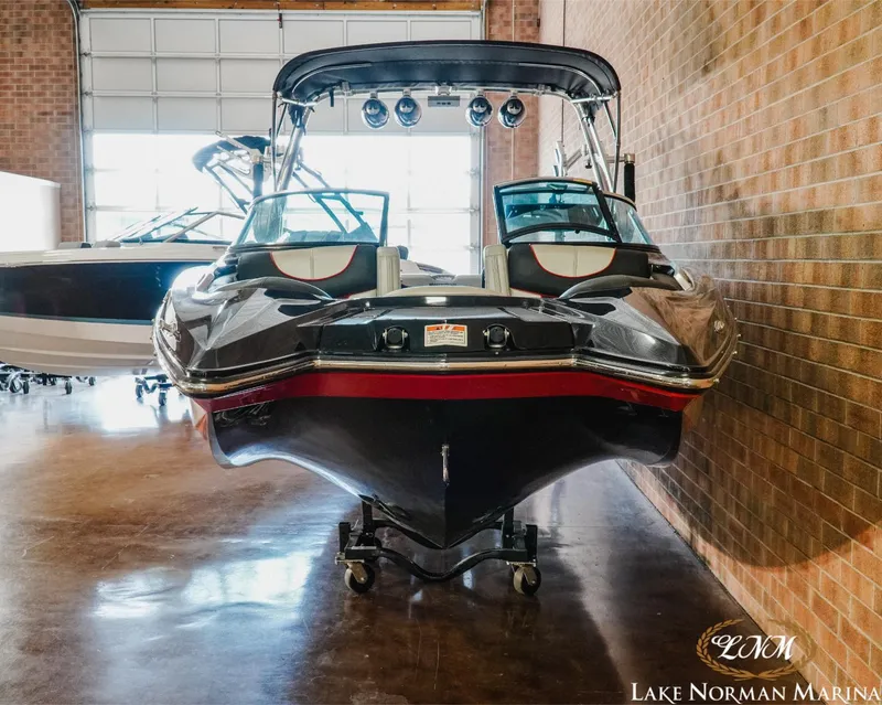 Slide: The Image of 2014 MasterCraft X-Star boat in indoor marina storage, front view. - 4