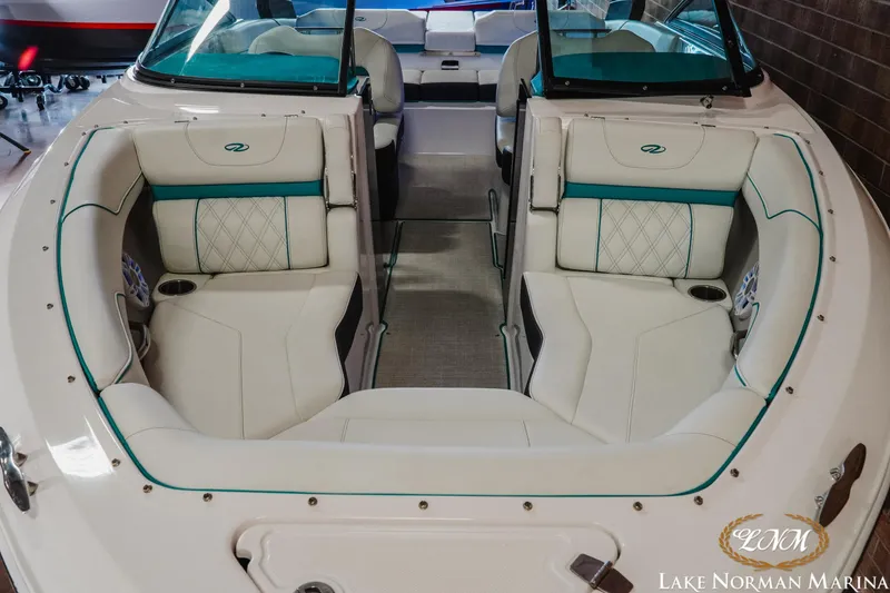 Slide: The Image of 2022 Regal LS2 Surf boat interior with white and teal seating at Lake Norman Marina. - 14