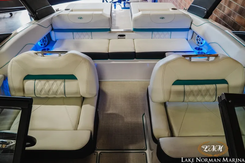 Slide: The Image of 2022 Regal LS2 Surf boat interior with luxurious seating and ambient blue lighting. - 16
