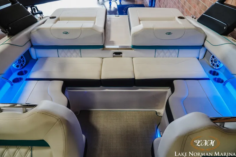 Slide: The Image of Luxurious interior of 2022 Regal LS2 Surf boat with blue LED lighting and comfortable seating. - 17