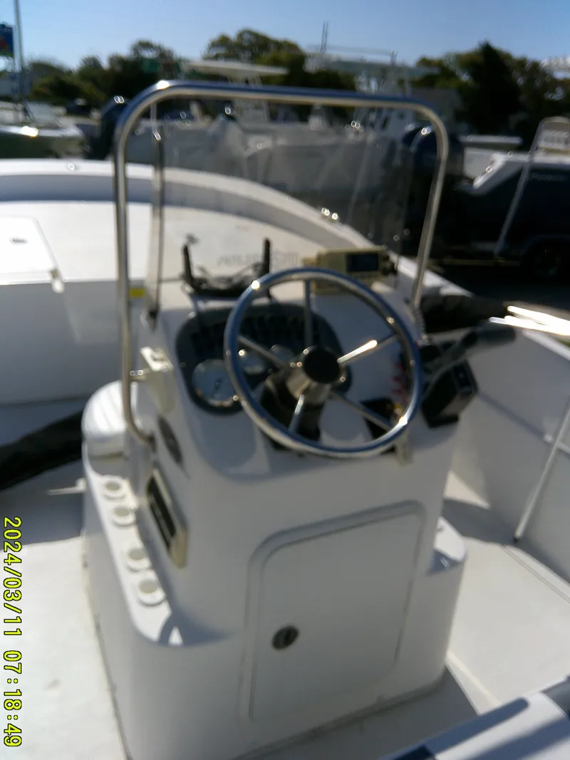 Slide: The Image of 2012 Carolina Skiff 198 DLV boat console with steering wheel and controls. - 12