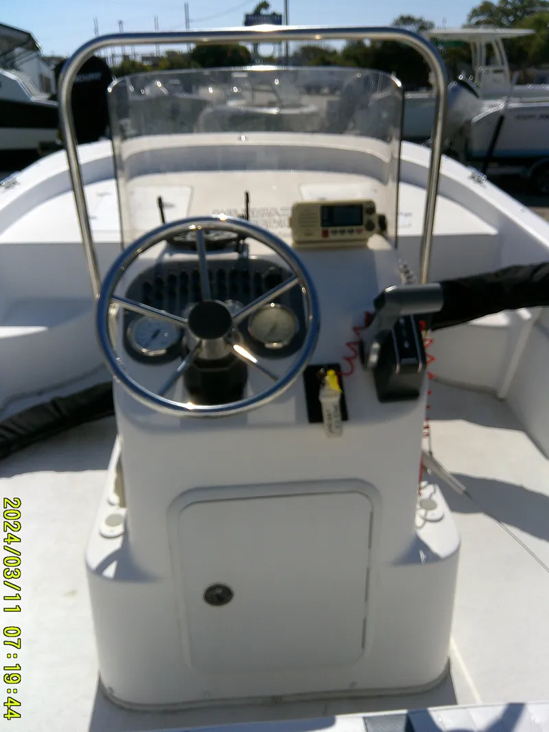 Slide: The Image of 2012 Carolina Skiff 198 DLV boat console with steering wheel and controls. - 14