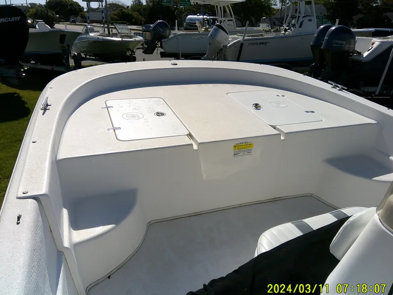 Slide: The Image of 2012 Carolina Skiff 198 DLV boat deck with storage compartments, photographed outdoors. - 8