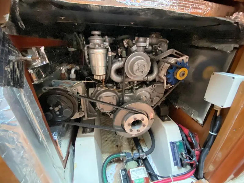 Slide: The Image of Engine compartment of a 2000 J Boats J/46 sailboat, showcasing mechanical components and wiring. - 12