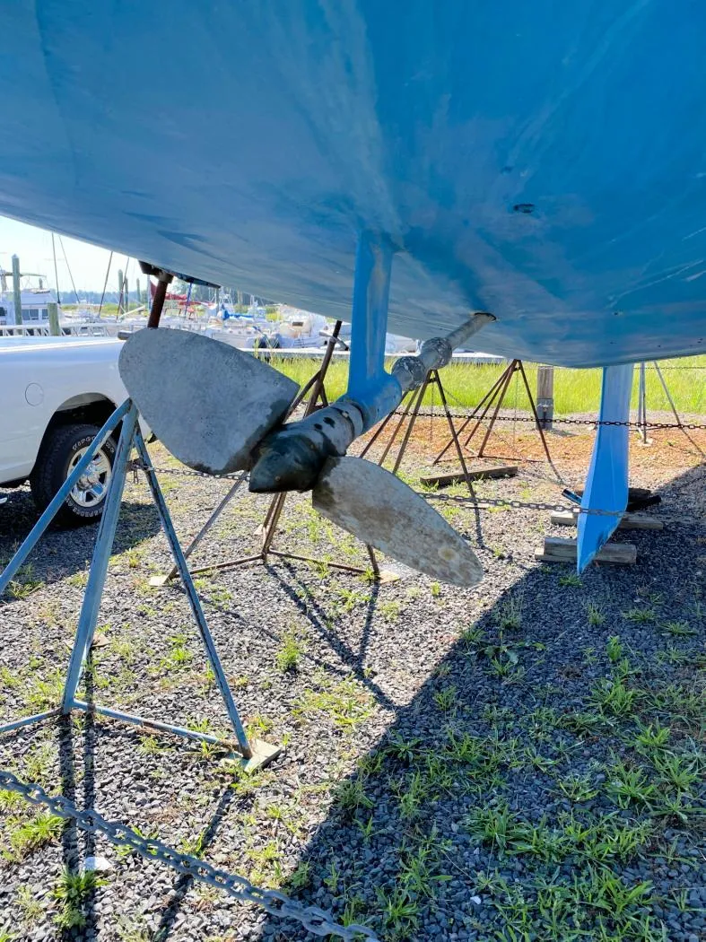 Slide: The Image of Propeller of 2000 J Boats J/46 sailboat on stands, blue hull, outdoor setting. - 15