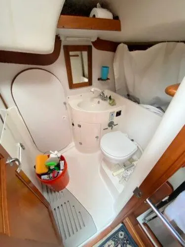 Slide: The Image of Bathroom interior of a 2000 J Boats J/46 yacht, featuring a compact sink and toilet. - 25