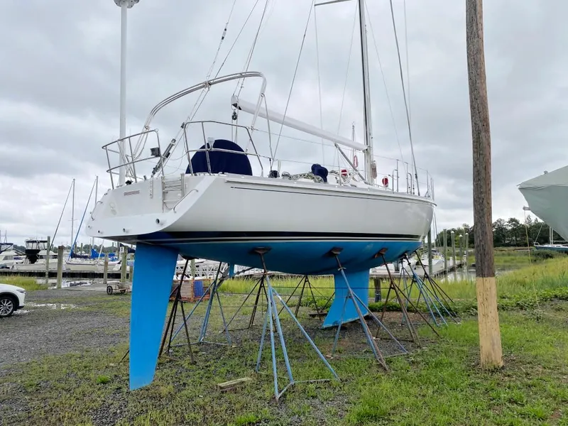 Slide: The Image of 2000 J Boats J/46 sailboat on stands in a marina, overcast sky. - 41