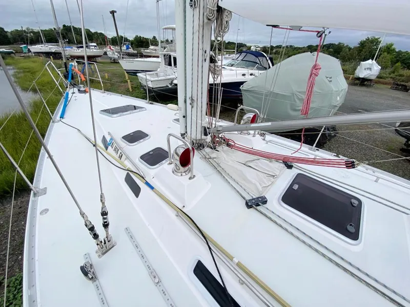Slide: The Image of Sailboat deck of 2000 J Boats J/46, docked with visible rigging and hatches. - 48