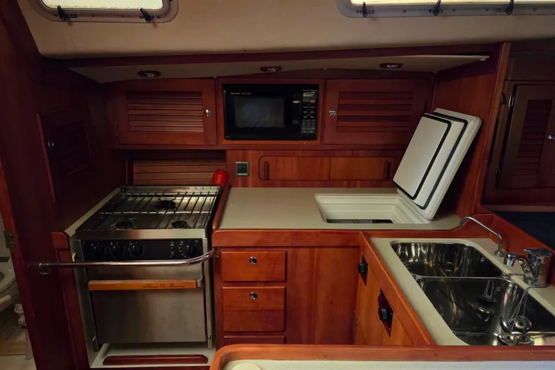 Slide: The Image of Luxurious 2000 J Boats J/46 yacht kitchen with stove, microwave, and sink. - 50