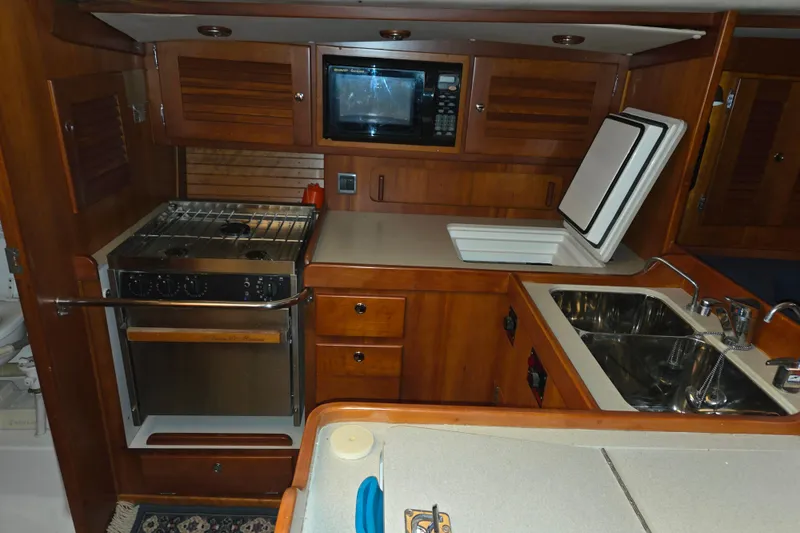 Slide: The Image of 2000 J Boats J/46 yacht galley with stove, microwave, and dual sinks. - 52