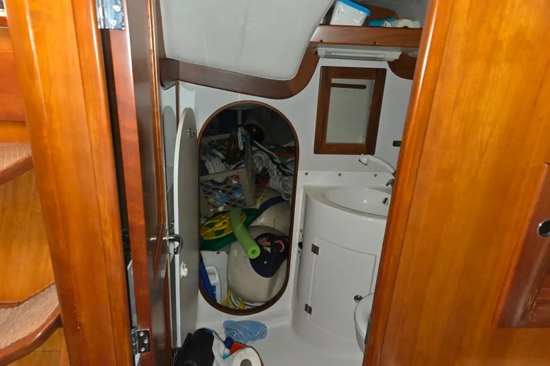 Slide: The Image of Cabin bathroom of 2000 J Boats J/46 yacht with wooden finish and storage items. - 60