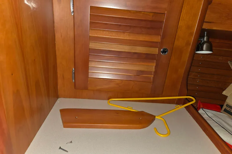 Slide: The Image of Interior of 2000 J Boats J/46 with wooden paneling and yellow hanger. - 61