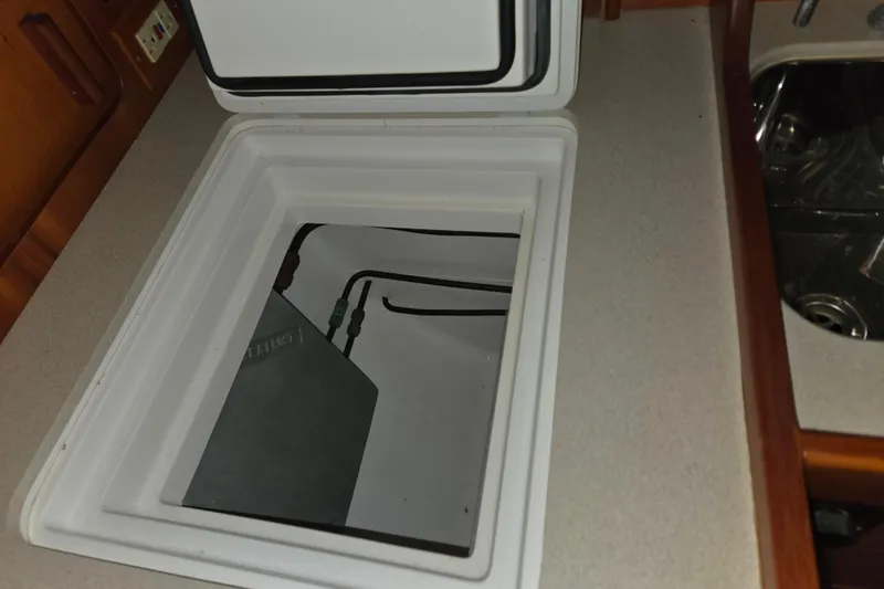 Slide: The Image of Open storage compartment in 2000 J Boats J/46 yacht galley. - 68