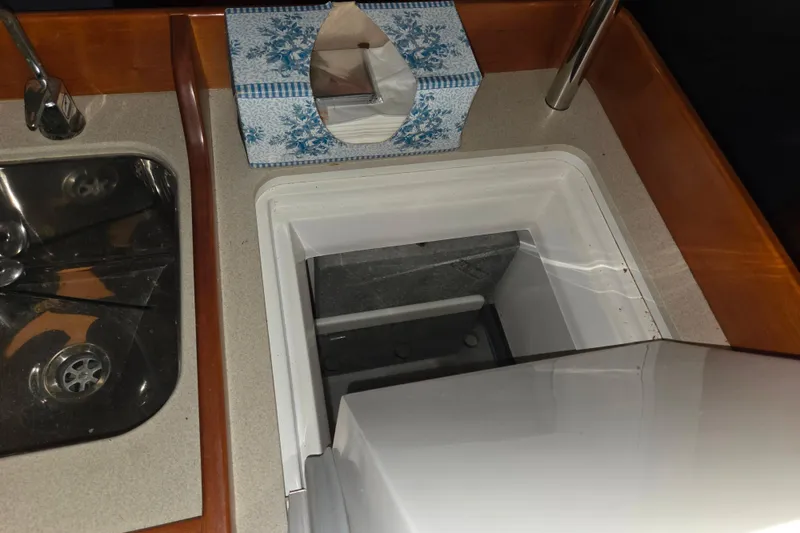 Slide: The Image of Galley sink and storage on 2000 J Boats J/46 yacht, with tissue box nearby. - 70