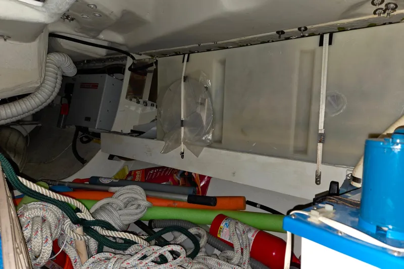 Slide: The Image of Interior of a 2000 J Boats J/46 sailboat, showing ropes and equipment storage. - 76