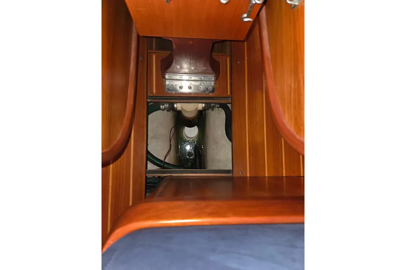 Slide: The Image of Interior view of 2000 J Boats J/46 sailboat, showcasing wooden cabinetry and mechanical components. - 78