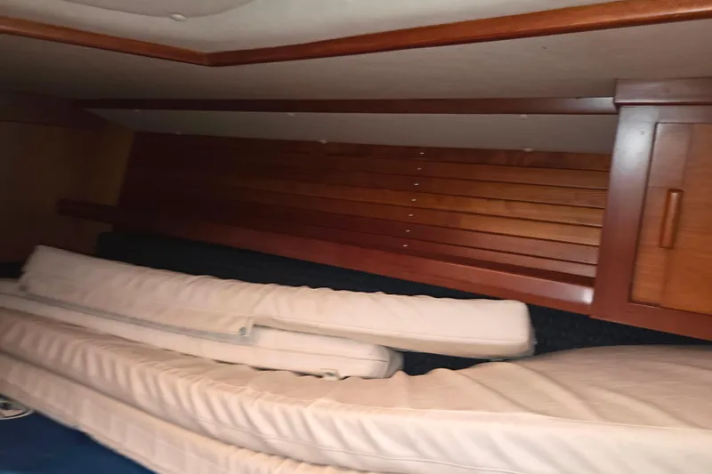 Slide: The Image of Interior cabin of 2000 J Boats J/46 with wooden paneling and cushions. - 84