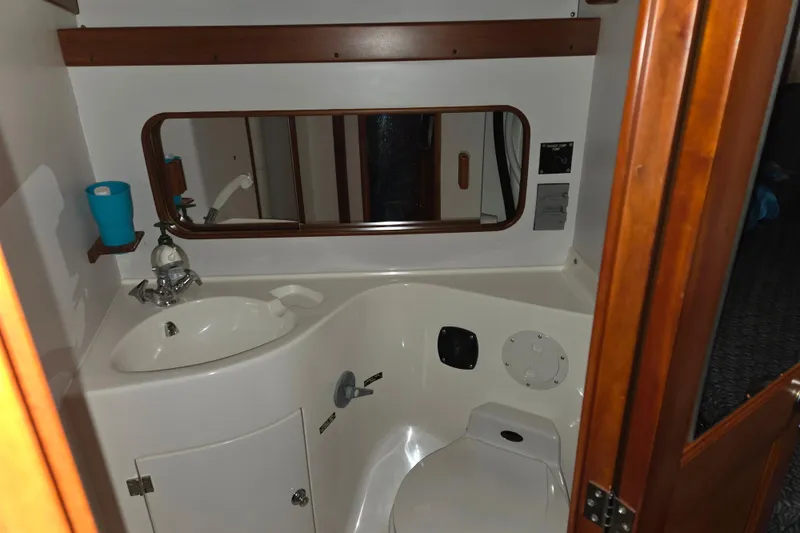 Slide: The Image of J Boats J/46 2000 yacht bathroom with sink, mirror, and toilet. - 86