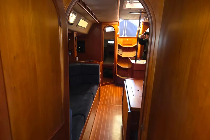 Slide: The Image of Interior of 2000 J Boats J/46 sailboat with wooden finish and cozy seating area. - 88