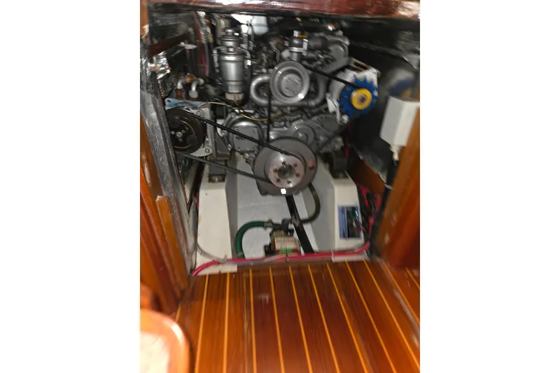 Slide: The Image of Engine compartment of a 2000 J Boats J/46 sailboat, showcasing mechanical components. - 90