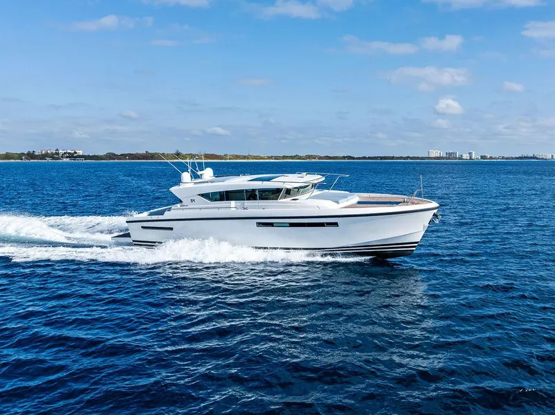 Slide: The Image of 2018 Delta Powerboats 54 IPS cruising on open blue water. - 10