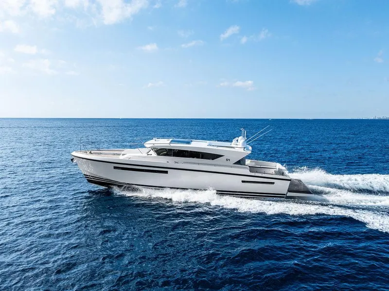 Slide: The Image of 2018 Delta Powerboats 54 IPS cruising on open sea under clear blue sky. - 11