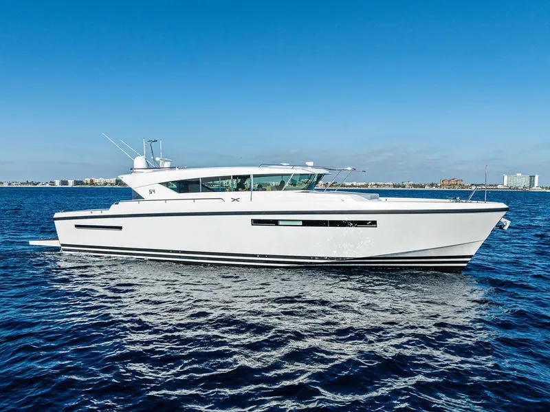 Slide: The Image of 2018 Delta Powerboats 54 IPS cruising on open water under clear blue skies. - 2