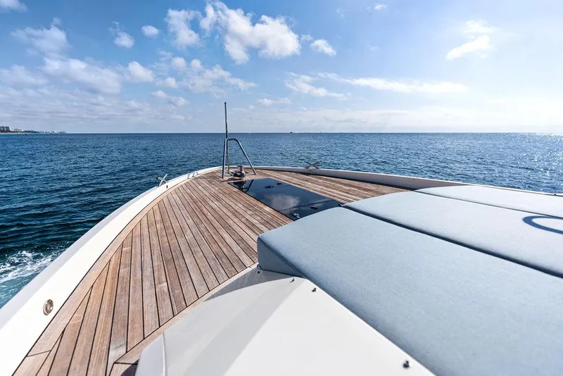 Slide: The Image of 2018 Delta Powerboats 54 IPS yacht on open sea, featuring sleek wooden deck. - 22