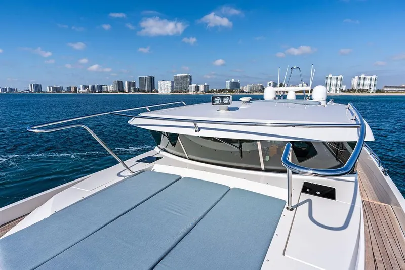 Slide: The Image of 2018 Delta Powerboats 54 IPS cruising near city skyline on a sunny day. - 27