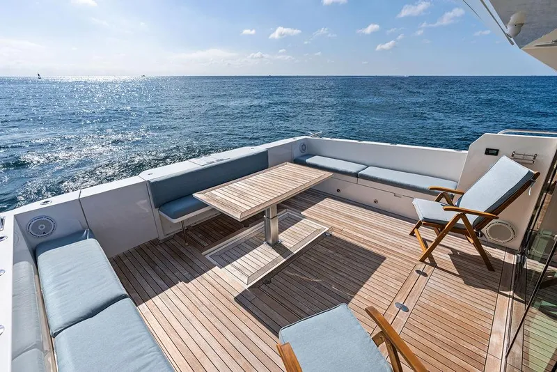 Slide: The Image of Luxurious 2018 Delta Powerboats 54 IPS yacht deck with seating, table, and ocean view. - 30