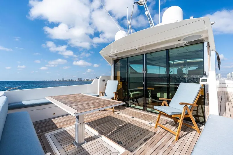 Slide: The Image of 2018 Delta Powerboats 54 IPS yacht deck with seating, table, and ocean view. - 32