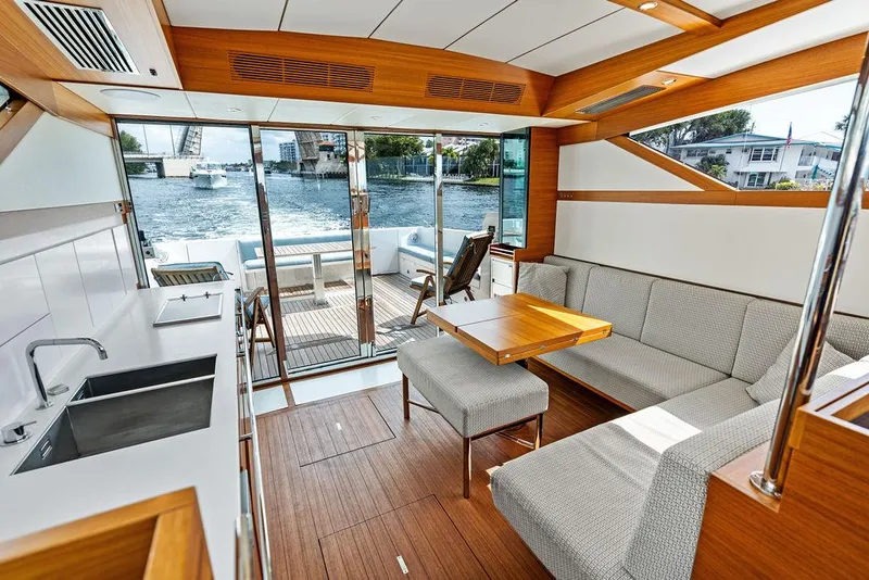 Slide: The Image of Interior of 2018 Delta Powerboats 54 IPS, featuring modern kitchen and seating area with waterfront view. - 38