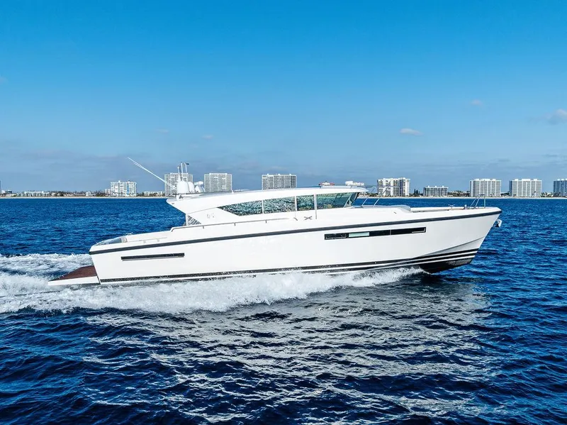 Slide: The Image of 2018 Delta Powerboats 54 IPS cruising on open water under clear blue skies. - 4