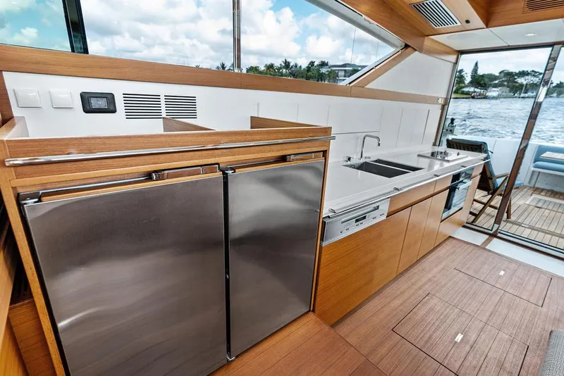 Slide: The Image of Modern kitchen interior on 2018 Delta Powerboats 54 IPS yacht, featuring sleek design and stainless appliances. - 43