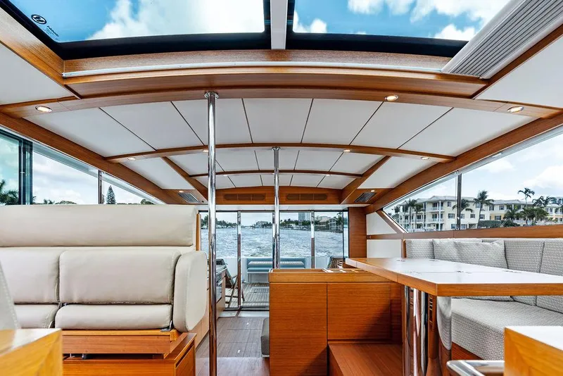 Slide: The Image of Interior of 2018 Delta Powerboats 54 IPS, featuring luxurious seating and panoramic windows. - 44