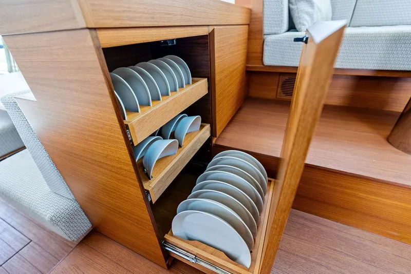 Slide: The Image of Wooden cabinet with organized plates on a 2018 Delta Powerboats 54 IPS. - 45