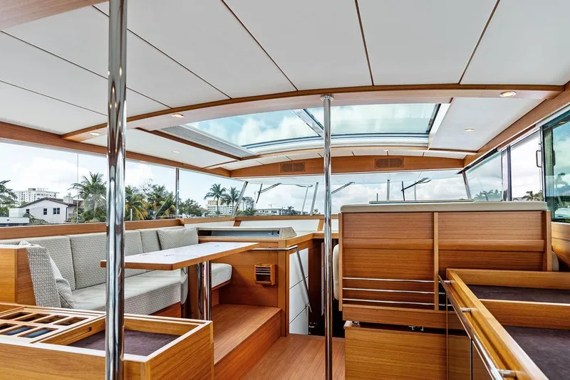 Slide: The Image of Interior of 2018 Delta Powerboats 54 IPS, featuring elegant wood finishes and spacious seating. - 46