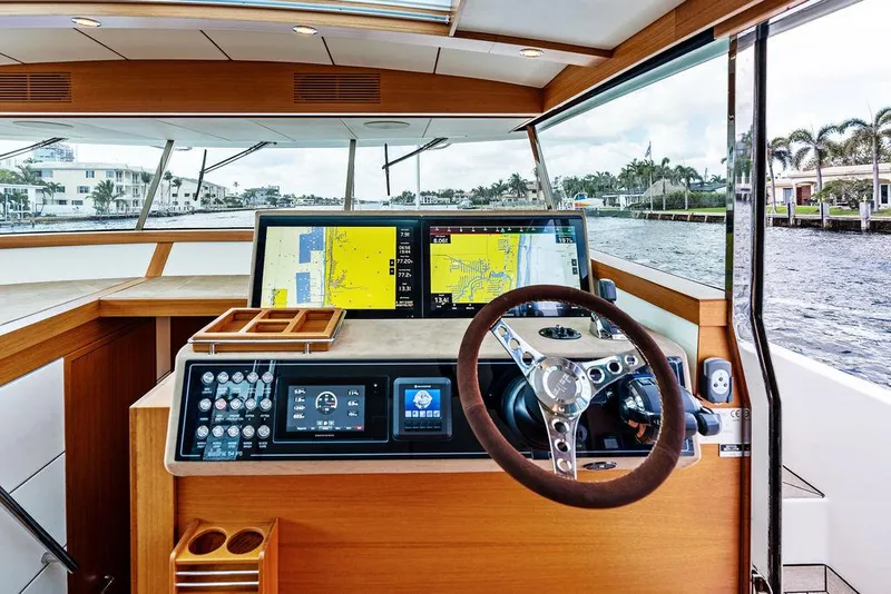 Slide: The Image of Helm of 2018 Delta Powerboats 54 IPS with navigation screens and steering wheel. - 48