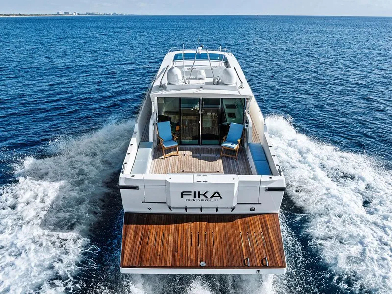 Slide: The Image of 2018 Delta Powerboats 54 IPS cruising on open sea, rear view with wooden deck. - 5
