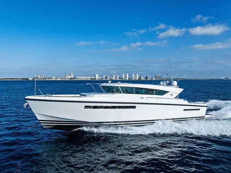 Slide: The Image of 2018 Delta Powerboats 54 IPS cruising on open water under clear blue skies. - 8