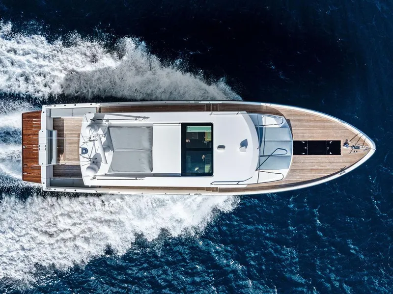 Slide: The Image of 2018 Delta Powerboats 54 IPS cruising on open water, aerial view. - 9